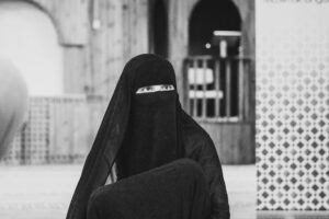 veiled muslim woman in mosque, black and white